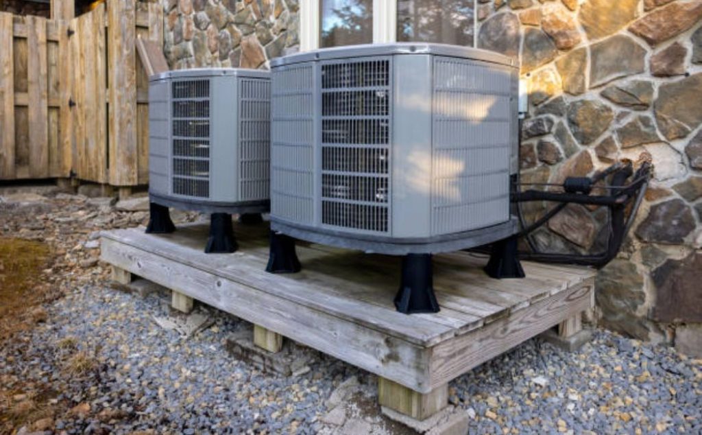 Residential home air heat pumps on platform for efficient cooling